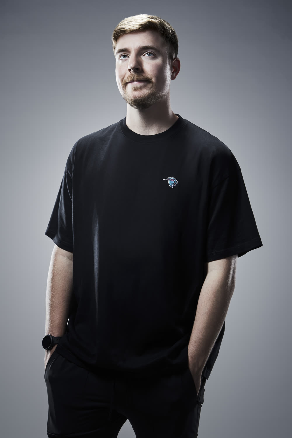 MrBeast standing against a gray studio background in 2023